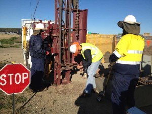 Engineer determining soil type from solid flight auger.